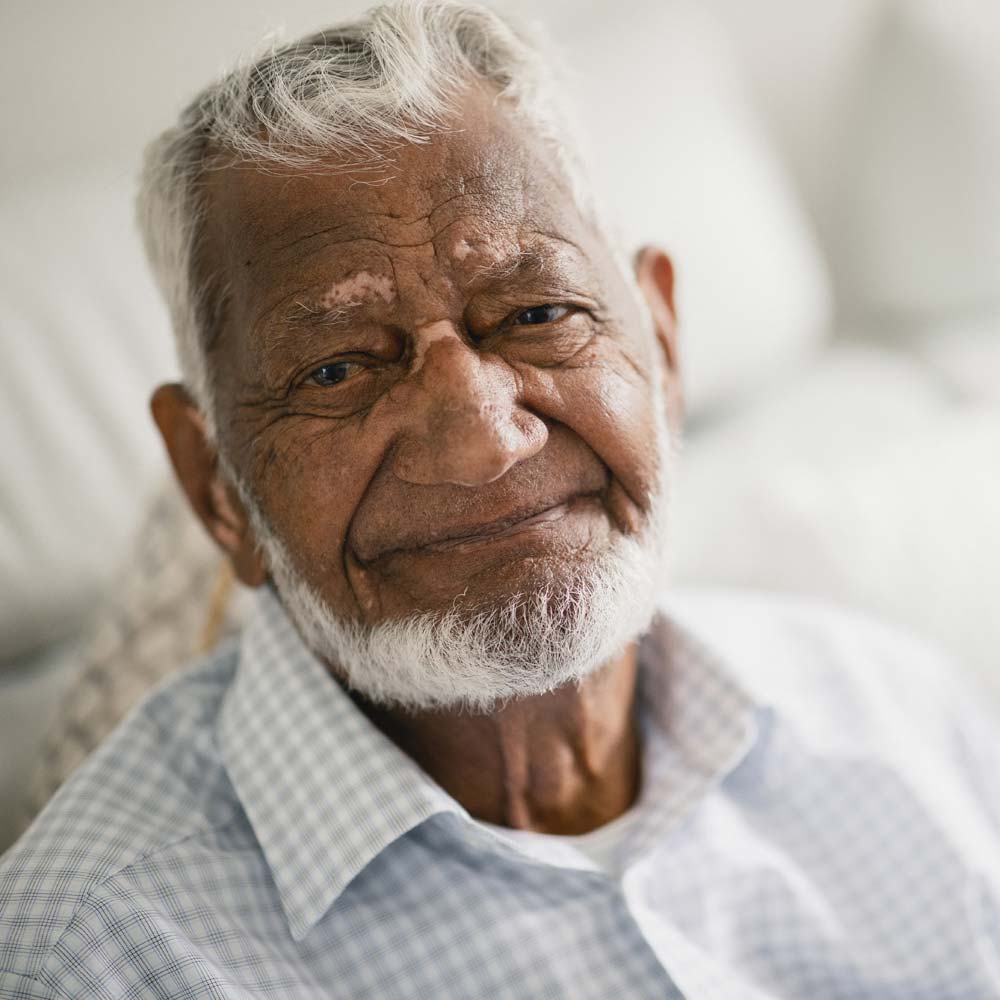 Closeup of male assisted living resident with beard smiling
