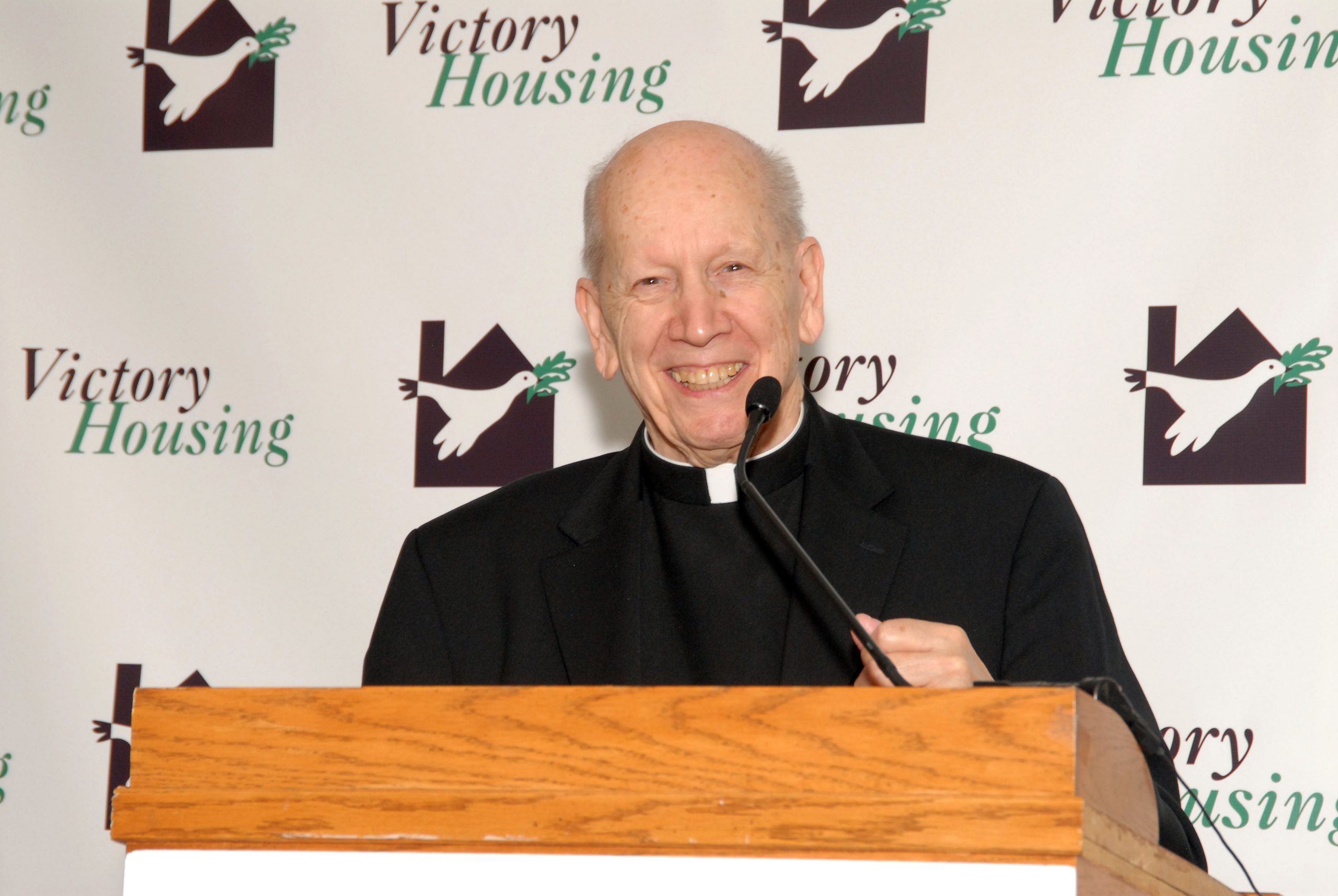 Msgr Kuehner at 30th anniversary Victory Housing founding father Monsignor Ralph J. Kuehner stands at podium to receive Washingtonian of the Year Award