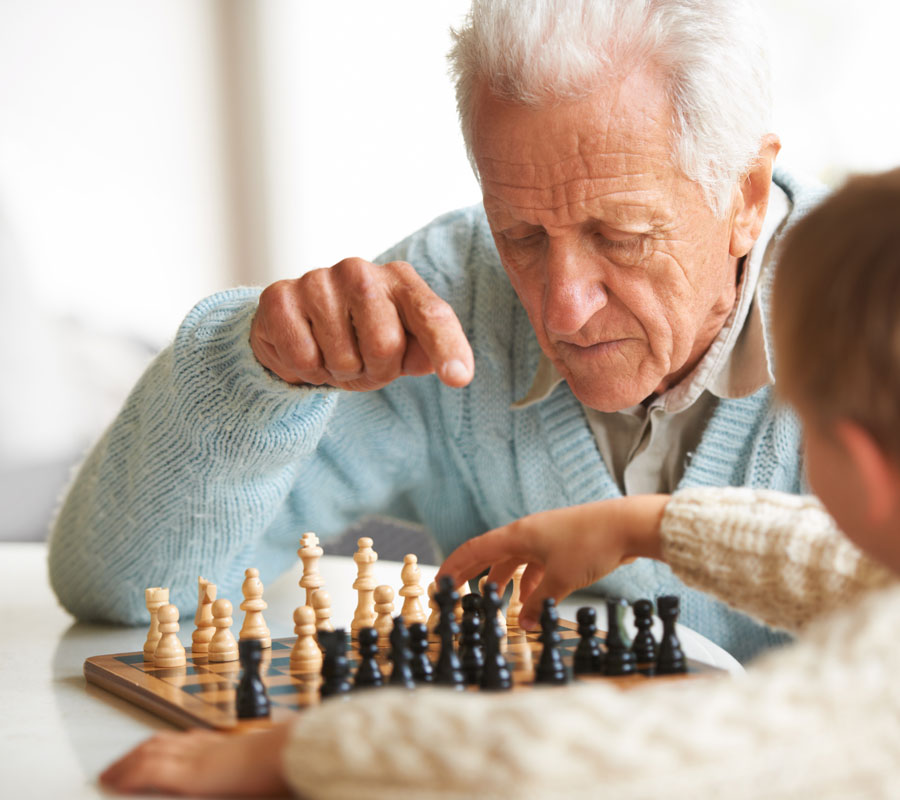 senior man playing chess